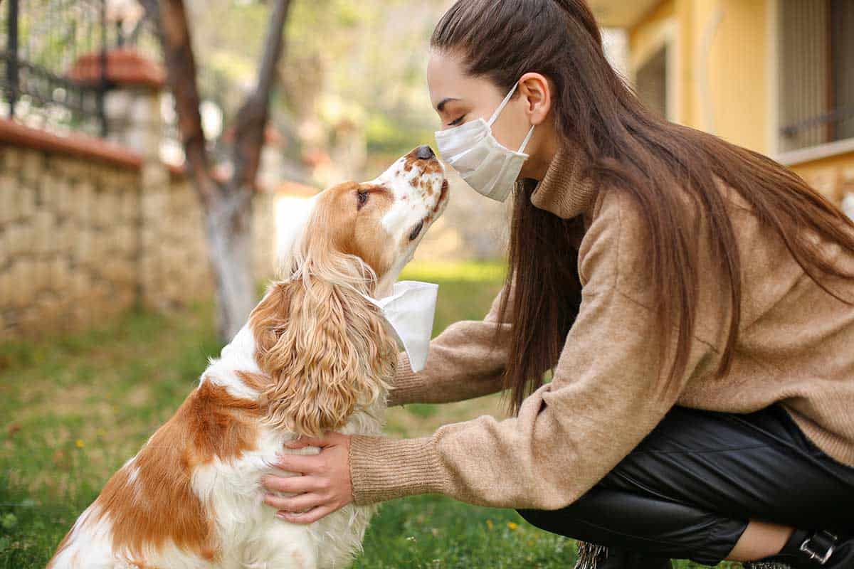 A woman and her dog in the outdoors A woman and her dog in the outdoors
